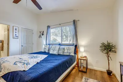 a bedroom with a bed with blue sheets and a window at Pet-Friendly Yard! Home 3 Mi to Sky River Casino in Elk Grove