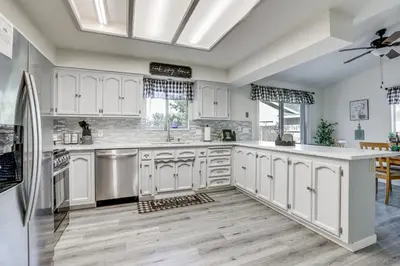 a large kitchen with white cabinets and a ceiling at Pet-Friendly Yard! Home 3 Mi to Sky River Casino in Elk Grove