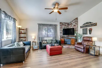 a living room with leather furniture and a ceiling fan at Pet-Friendly Yard! Home 3 Mi to Sky River Casino in Elk Grove