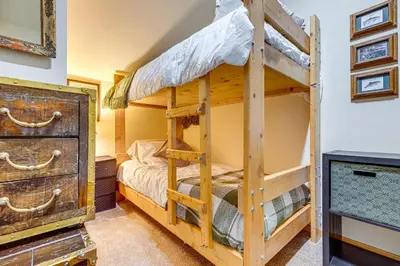 a bedroom with a bunk bed and a dresser at 1 Mi to Skiing! Cabin Hideaway on June Lake Loop in June Lake