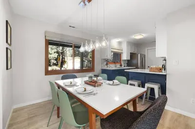a kitchen and dining room with a table and chairs at Stellars Jay Getaway Pet Friendly in City of SLT in South Lake Tahoe