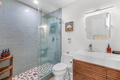 a bathroom with a shower and a toilet and a sink at Stellars Jay Getaway Pet Friendly in City of SLT in South Lake Tahoe