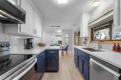 a kitchen with blue cabinets and a sink at Stellars Jay Getaway Pet Friendly in City of SLT in South Lake Tahoe
