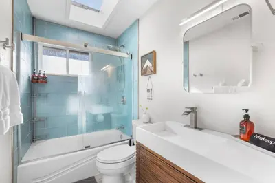 a bathroom with a tub and a toilet and a sink at Stellars Jay Getaway Pet Friendly in City of SLT in South Lake Tahoe