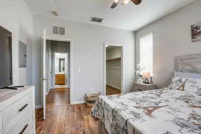 a white bedroom with a bed and a television at Extended-Stay Ready! Elk Grove Unit with Pool Access in Elk Grove