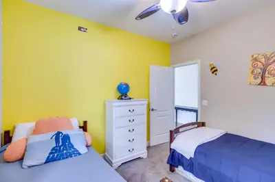 a bedroom with two beds and a yellow wall at Family-Friendly Retreat with Playground in Reno! in Reno