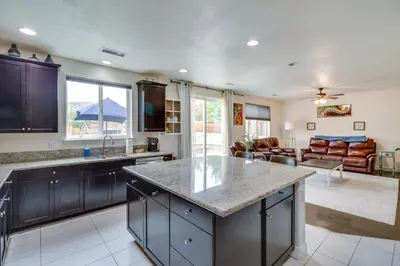 a kitchen with a large counter top and a living room at Family-Friendly Retreat with Playground in Reno! in Reno