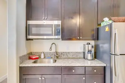 a kitchen with a sink and a refrigerator at Hike, Play and Unwind Charming Reno Unit in Reno