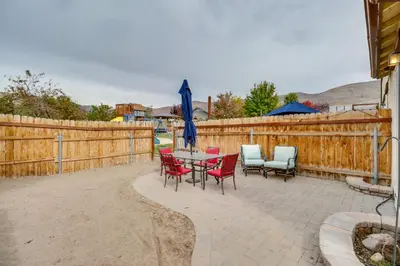 a patio with a table and chairs and a fence at Hike, Play and Unwind Charming Reno Unit in Reno