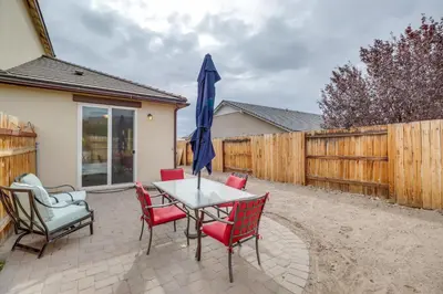 a patio with a table and chairs and an umbrella at Hike, Play and Unwind Charming Reno Unit in Reno