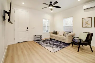 a living room with a couch and a ceiling fan at Modern Cozy and contemporary in Ione