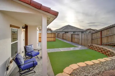 a patio with two chairs and a lawn at Modern Cozy and contemporary in Ione