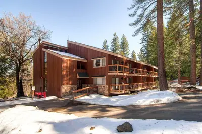 a house in the woods in the snow at (A108) Studio Condominiums in Yosemite West