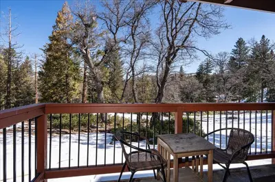 a porch with two chairs and a table on a balcony at (A111) Studio Condominiums in Yosemite West