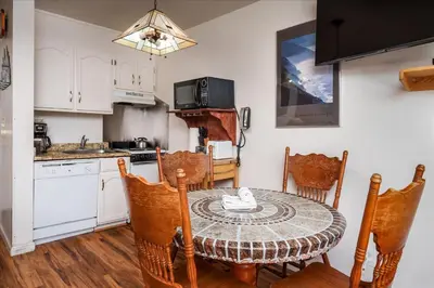 a kitchen and dining room with a table and chairs at (A111) Studio Condominiums in Yosemite West
