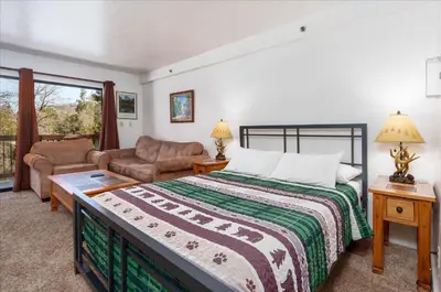 a bedroom with a bed and a living room at (A109) Studio Condominiums in Yosemite West