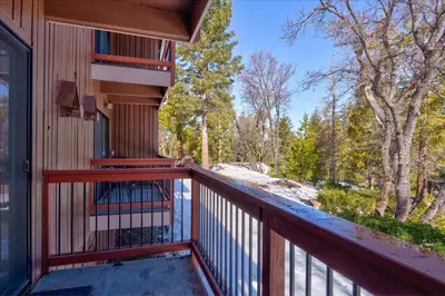 a balcony with a view of the woods at (A109) Studio Condominiums in Yosemite West
