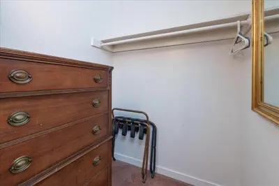 a bedroom with a wooden dresser and a closet at (A202) Loft Condominiums in Yosemite West