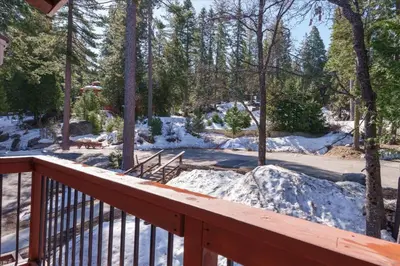 a wooden deck with snow on the ground at (A202) Loft Condominiums in Yosemite West