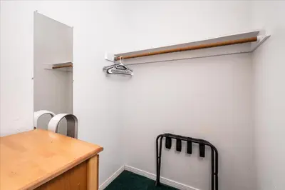 a room with a white wall with a desk and a chair at (A204) Loft Condominiums in Yosemite West