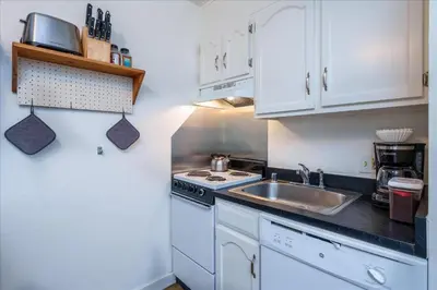 a small kitchen with white cabinets and a sink at (A110) Studio Condominiums in Yosemite West