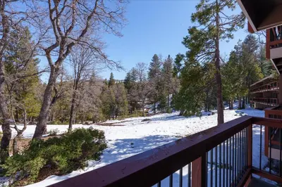 a view from the balcony of a house with snow on the ground at (A110) Studio Condominiums in Yosemite West