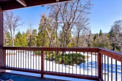 a balcony with a view of the woods at (A110) Studio Condominiums in Yosemite West
