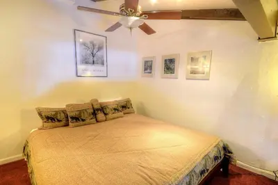 a bedroom with a bed with a ceiling fan at (A207) Loft Condominiums in Yosemite West
