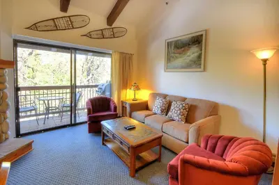 a living room with a couch and chairs and a balcony at (A211) Loft Condominiums in Yosemite West
