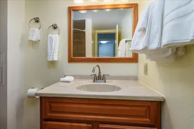 a bathroom with a sink and a mirror and towels at (B208) Loft Condominiums in Yosemite West