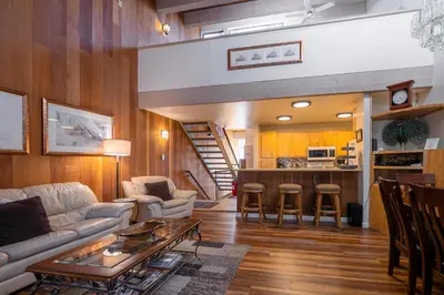 a living room with a couch and a table at Creekside Chalet Stay for 6 in Kings Beach
