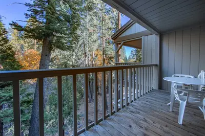 a deck with a table and chairs on it at Creekside Chalet Stay for 6 in Kings Beach