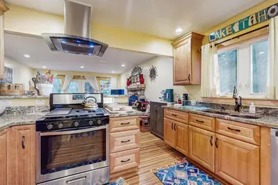 a kitchen with wooden cabinets and a stove top oven at Colorado Pines Retreat in South Lake Tahoe
