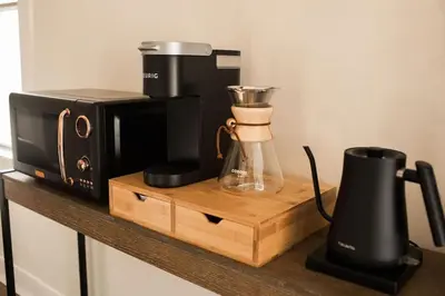 a microwave and a coffee maker on a wooden shelf at Yosemite Cottage Retreat- Half Block to Downtown in Mariposa