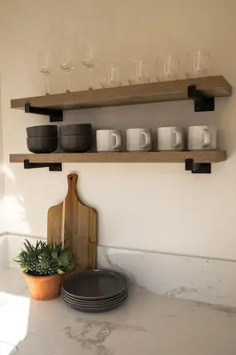 a shelf with glasses and plates on a wall at Yosemite Cottage Retreat- Half Block to Downtown in Mariposa