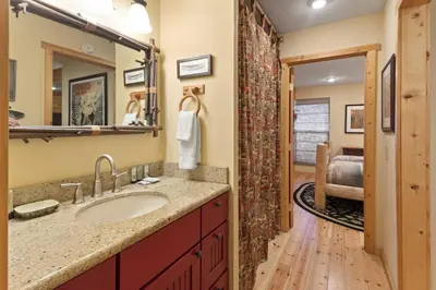 a bathroom with a sink and a mirror at Chamonix #15 - Cozy Mtn Retreat with Fireplace in Mammoth Lakes