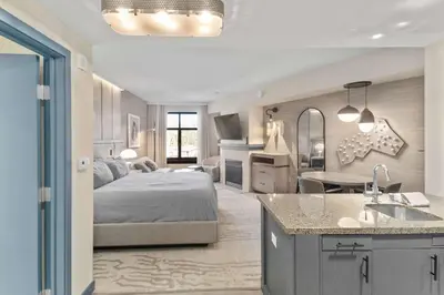 a bedroom with a bed and a kitchen with a sink at Hillside #508 - Cozy Studio w King Bed Fireplace & Kitchenette in Mammoth Lakes