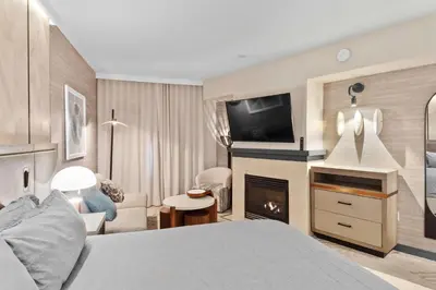 a hotel room with a bed and a fireplace at Hillside #508 - Cozy Studio w King Bed Fireplace & Kitchenette in Mammoth Lakes