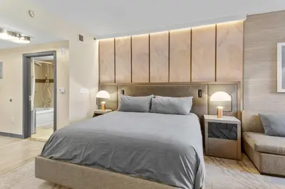 a bedroom with a large bed and a couch at Hillside #508 - Cozy Studio w King Bed Fireplace & Kitchenette in Mammoth Lakes