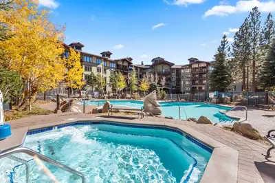 a swimming pool at a apartment complex with a building at The Village #2408 - Village Center Cozy Getaway w Fireplace in Mammoth Lakes