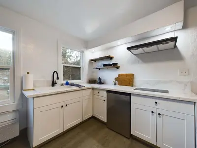 a kitchen with white cabinets and a sink at Family Getaway Near Yosemite - Downtown Mariposa in Mariposa