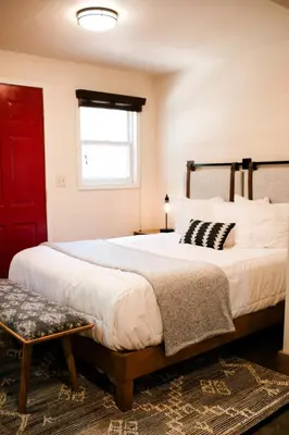 a bedroom with two beds and a red door at Family Getaway Near Yosemite - Downtown Mariposa in Mariposa