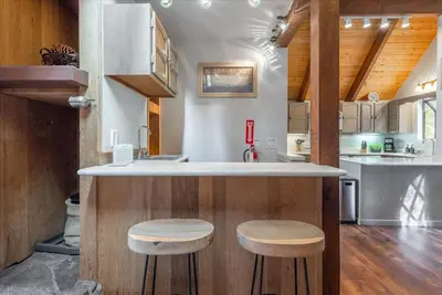 a kitchen with a counter and stools in a room at Martis Landing home in Truckee