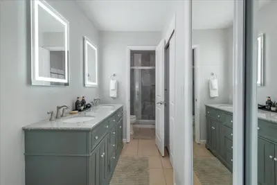 a bathroom with two sinks and two mirrors at Martis Landing home in Truckee
