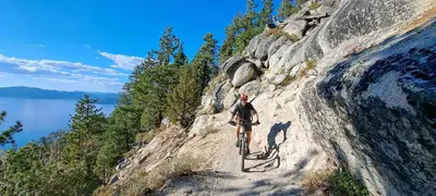 a person riding a bike on a dirt trail at Dav's Slopeside King Studio -- Resort & Spa at Everline in Olympic Valley