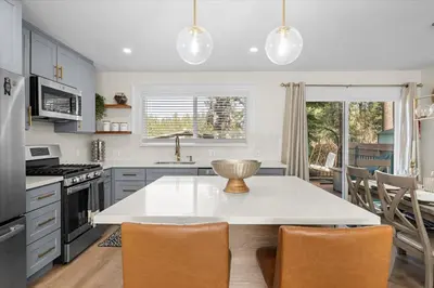 a kitchen with a white table and chairs in it at Luxury Hyatt Oasis 3 Bedrms 1 Bath SFH for Fun Ski home in South Lake Tahoe