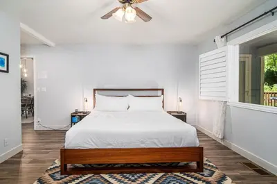 a bedroom with a bed and a ceiling fan at Serenity Pines 1hr to Yosemite w BBQ and Game Room in Mariposa