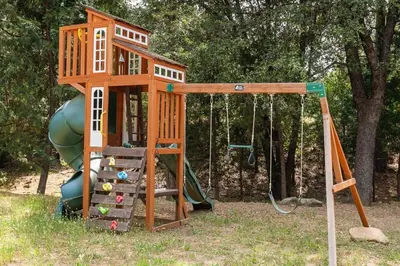 a playground with a tree house and a slide at Serenity Pines 1hr to Yosemite w BBQ and Game Room in Mariposa