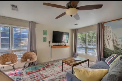 a living room with a couch and a ceiling fan at Hillside Bungalow - Walking distance to downtown in Mariposa