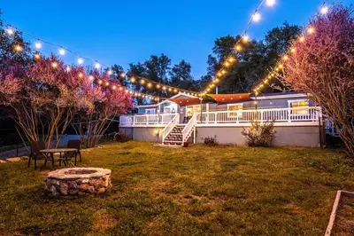 a yard with a lot of lights and a house at The Nest-2 K Beds-Game Room-Deck-5 min to Mariposa in Mariposa